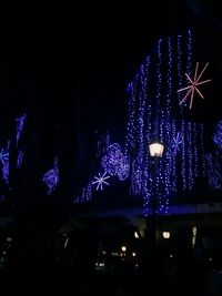 Low angle view of firework display at night