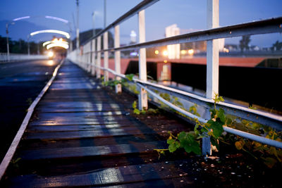 Illuminated bridge against sky at night