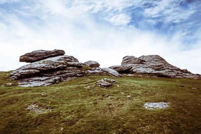 Rock formations on landscape against sky