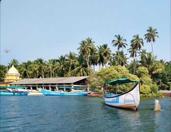 Boats in blue sea against clear sky