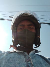 Low angle view of man wearing sunglasses against sky