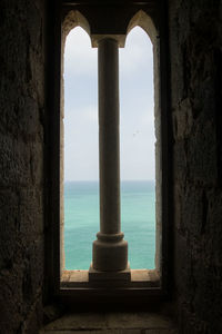 View of sea seen through window