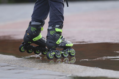 Low section of man walking on city street