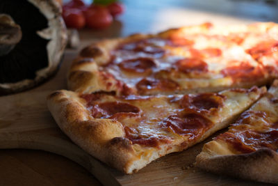 High angle view of pizza on cutting board