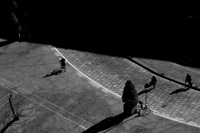 High angle view of people on street at sunny day