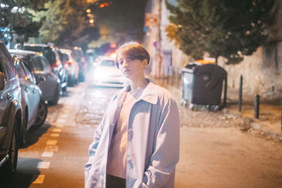 Man standing on street in city