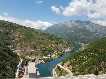 High angle view of river amidst mountains against sky