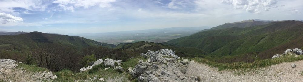 Scenic view of mountains against cloudy sky