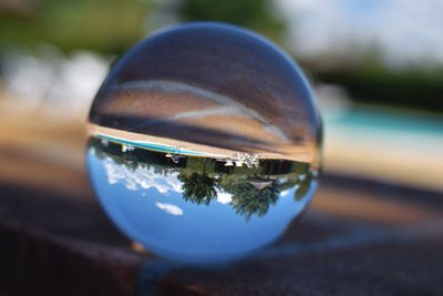 Close-up of glass with ball on table