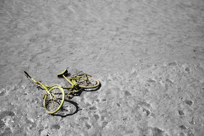 High angle view of bicycle on sand