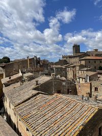 High angle view of buildings in town against sky
