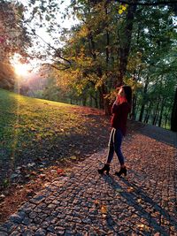 Man walking on footpath during autumn