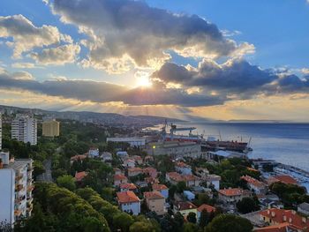 High angle view of townscape by sea against sky