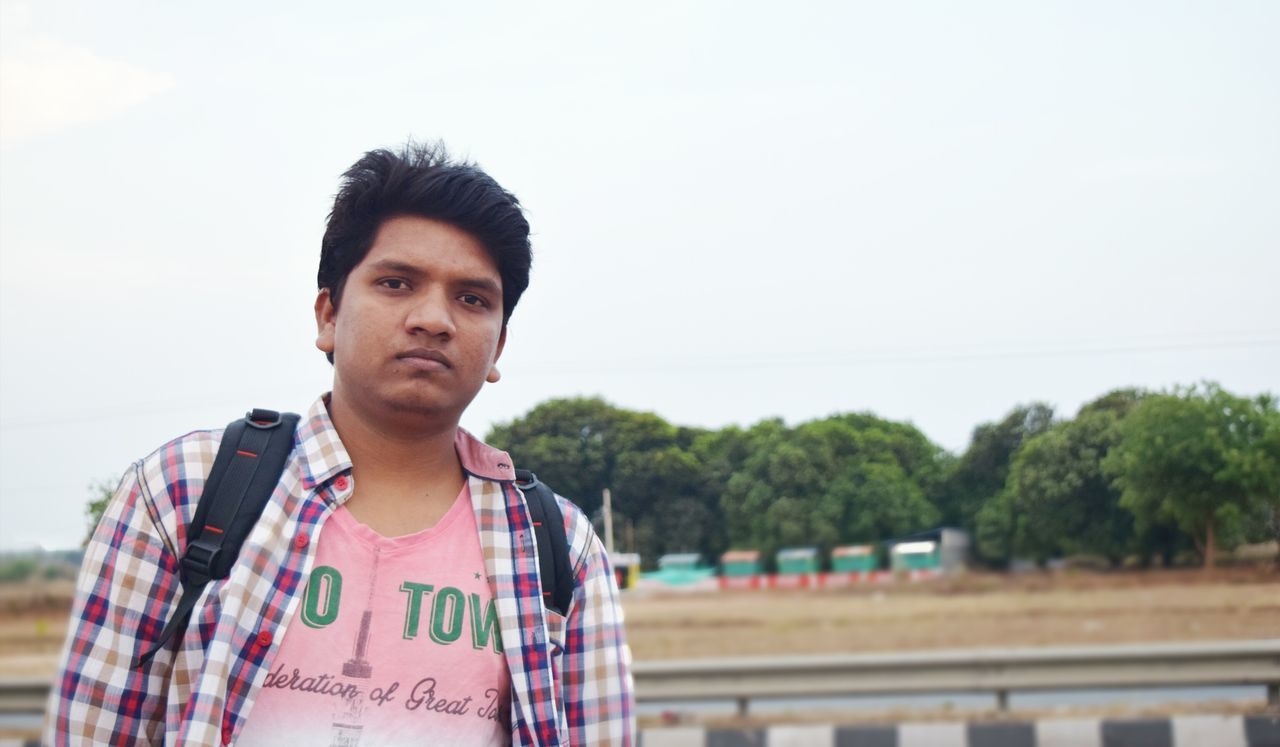 lifestyles, person, leisure activity, looking at camera, portrait, casual clothing, smiling, front view, clear sky, happiness, young men, young adult, elementary age, standing, headshot, childhood, focus on foreground