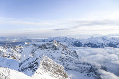 Scenic view of snowcapped mountains against sky