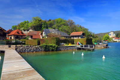 Houses by annecy lake against sky in city