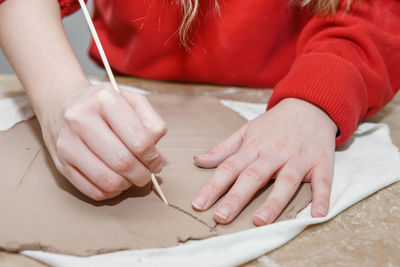 Women's hands knead clay, drawing elements of the product. production of ceramic products
