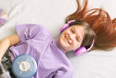 High angle view of cute baby girl lying on bed at home