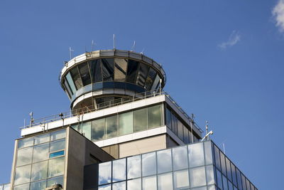 Low angle view of modern building against clear blue sky