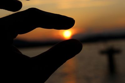 Cropped image of man against sky at sunset