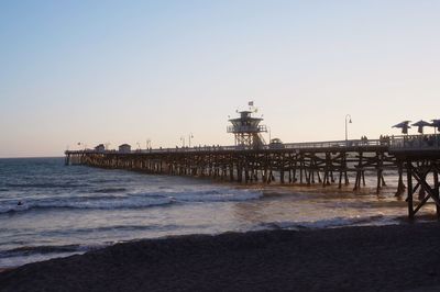 Pier on sea at sunset