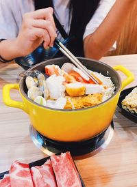 Midsection of woman holding ice cream in bowl