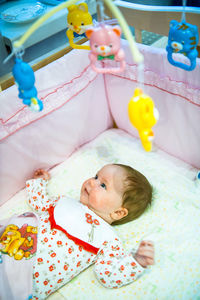 High angle view of cute baby boy sleeping on bed at home