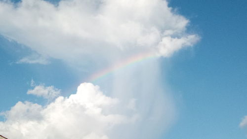 Low angle view of rainbow in sky