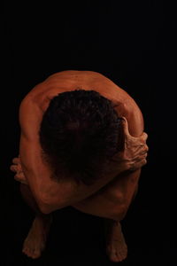 Close-up of baby against black background