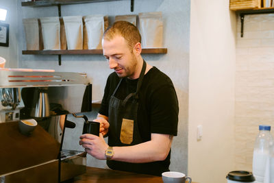 Young man working in kitchen