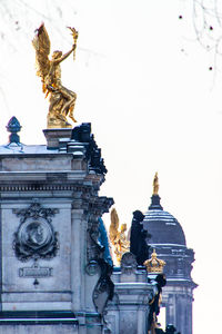 Low angle view of statue against building