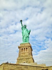 Statue of liberty against cloudy sky