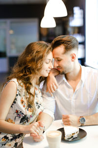 Couple embracing at cafe