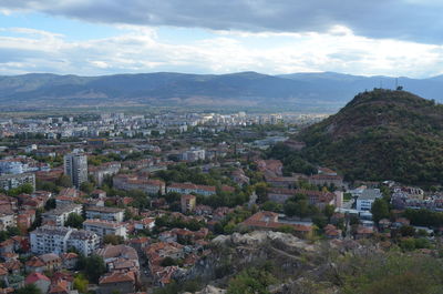 Cityscape against cloudy sky