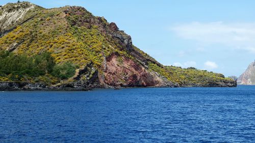 Scenic view of sea and rock formation against sky