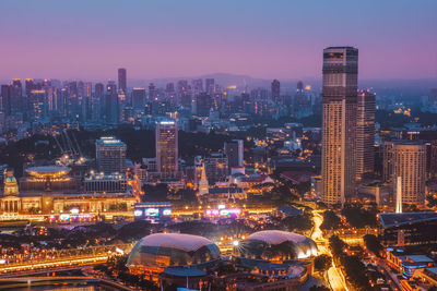 Aerial view of illuminated buildings in city at night