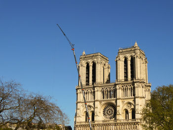 Low angle view of notre dame de paris against clear blue sky