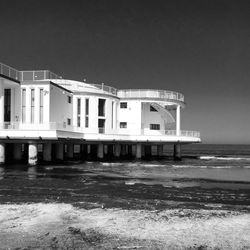 View of built structure by sea