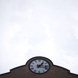 Low angle view of clock tower against sky