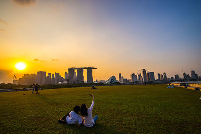 People in city at sunset