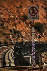 Close-up of road sign on railroad track