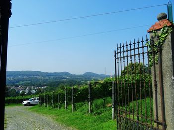 Cars on mountain road against clear sky