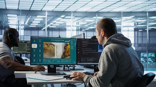 Rear view of man working at office