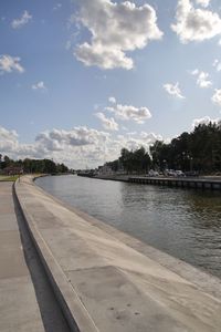 Scenic view of river by city against sky