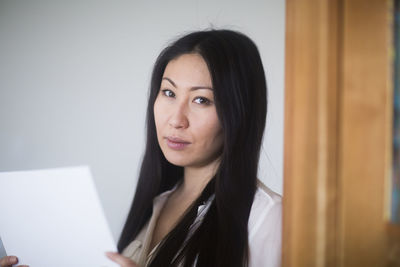 Young woman at home with paper revised