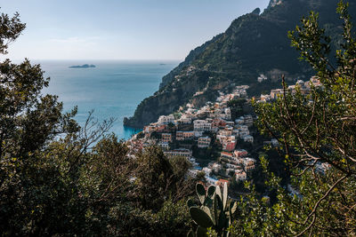 High angle view of townscape by sea against sky