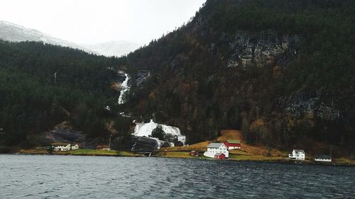 Scenic view of river and mountains against sky