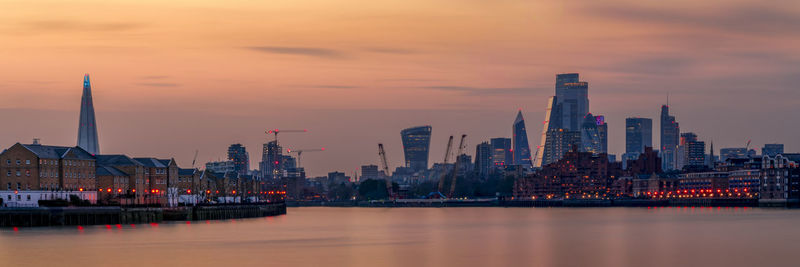 City at waterfront during sunset