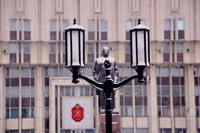 Close-up of street light against building