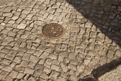 High angle view of manhole on footpath